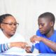 A clinical officer attached to HOPE mbale attends to a youth during the week long campaign at Mutoto