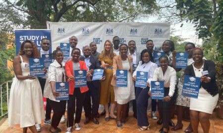 Deputy British High Commissioner Tiffany Kirlew with 20 Ugandan scholars bound for the UK under the