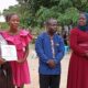 Minister Namuyangu issuing Certificate to Students 1000x600