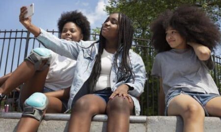 Teenage black girls spending time together outdoors weight issues