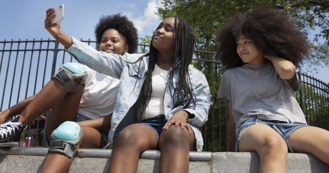 Teenage black girls spending time together outdoors weight issues