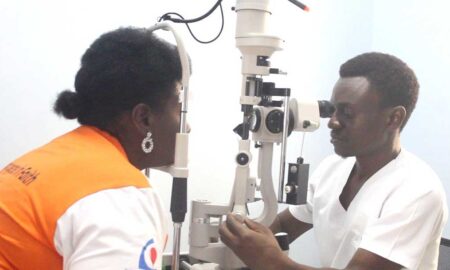 A doctor examines a patient at the AMDA Medical Camp in Rushooka Ntungamo