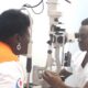 A doctor examines a patient at the AMDA Medical Camp in Rushooka Ntungamo