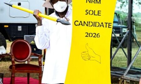 President Museveni displays a spear and shield after receiving them from Speaker of Parliament Anita