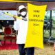 President Museveni displays a spear and shield after receiving them from Speaker of Parliament Anita